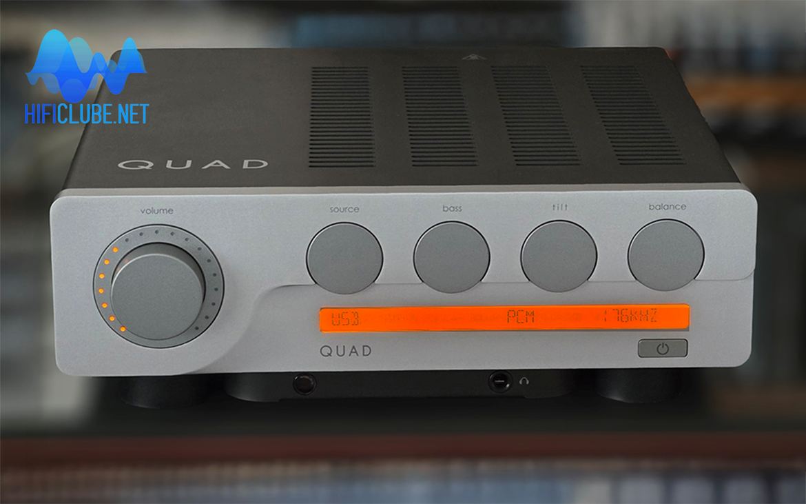 The front panel is dominated by five rotary knobs, the largest being the volume control, which features a luminous arc of orange LEDs.