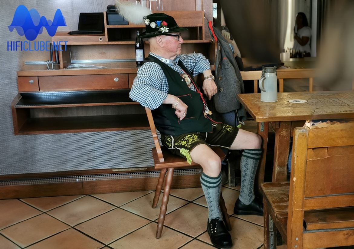 Typical bavarian senior enjoying a beer in a tavern, dressed up in Tyrolean costume.